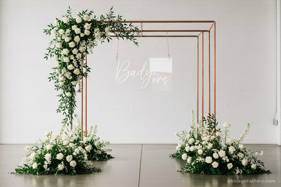 Full view of a clear acrylic welcome sign hanging from a copper pipe stand with floral accents